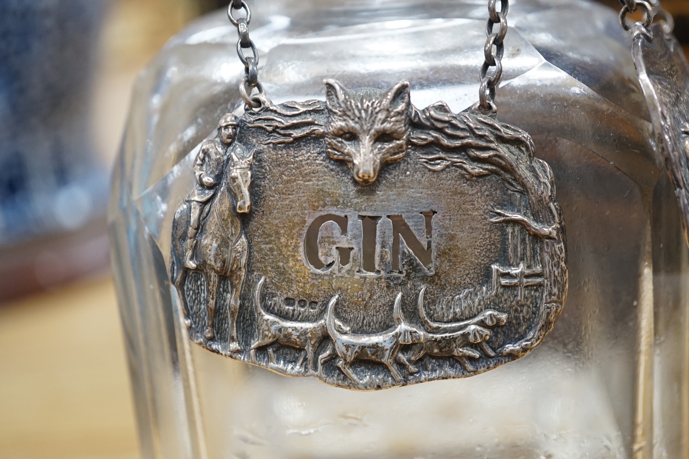 A Victorian coromandel four bottle decanter box with Bramah lock, three silver ‘hunting’ spirit labels and another enamelled, height of box 30cm